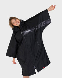 Adult female in studio wearing Dryrobe® black grey remix
