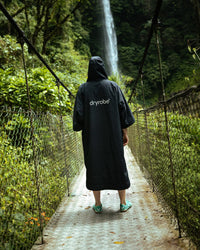Female on bridge in front of waterfall wearing Tech-Lite Dryrobe®