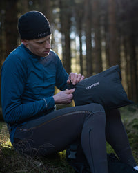 *MALE* in woods unpacking Tech-Lite Dryrobe® after run