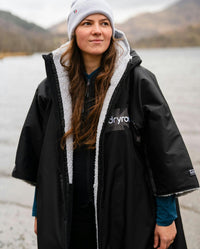 Adult female by lake wearing Dryrobe® black grey remix