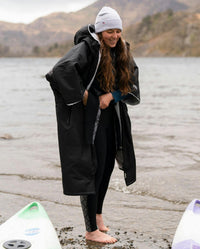 Adult female by lake wearing Dryrobe® black grey remix