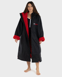 Woman wearing dryrobe Advance Long Sleeve changing robe in Black Red