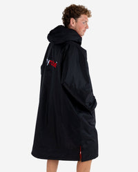 *MALE*  Man stood facing sideways wearing dryrobe Advance Long Sleeve changing robe in Black Red