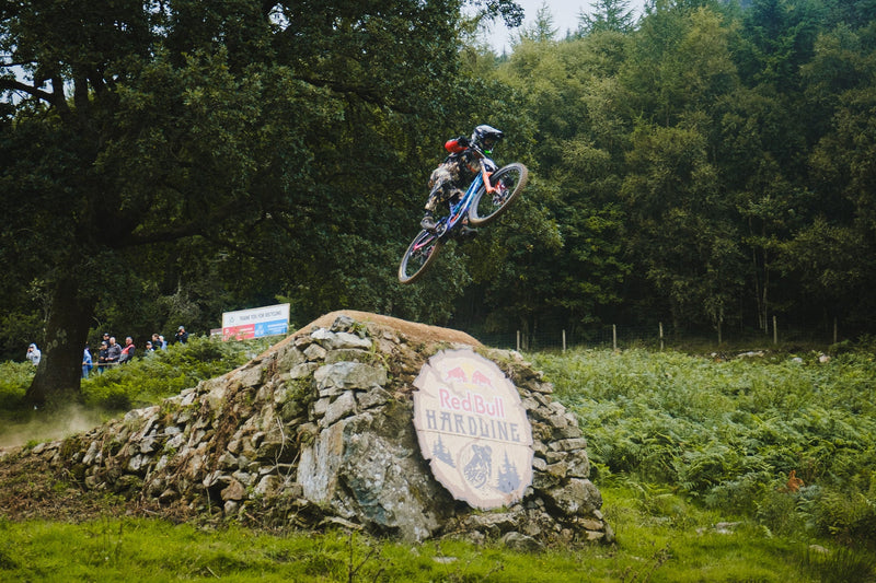 A MTB rider making a jump at Red Bull Hardline 2025