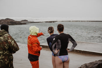 RNLI Lifeguard Richard Heard, Keri-anne Payne, Sophie Hellyer looking at the sea