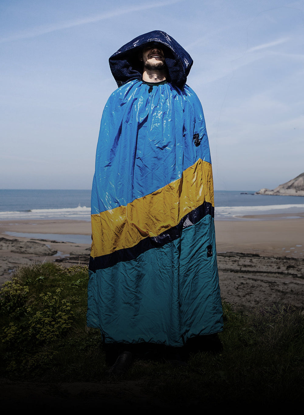 Adult male on the beach wearing the original Dryrobe® 