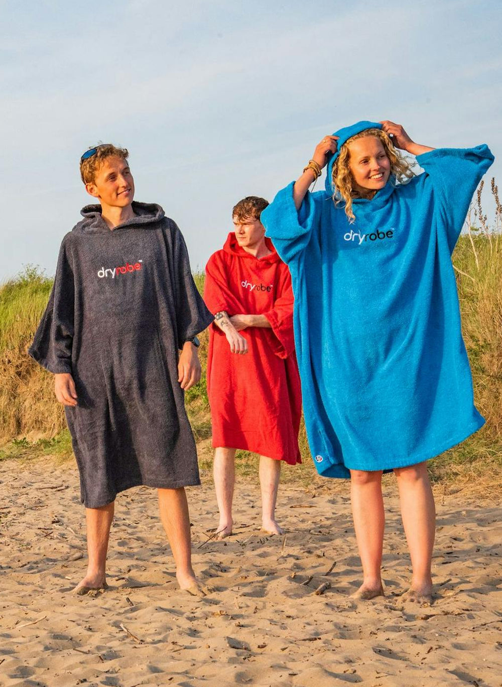 Group of young adults wearing Dryrobe® organic towel changing robes 