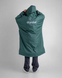 *MALE* in studio wearing AW25 Green Dryrobe® advance long sleeve 
