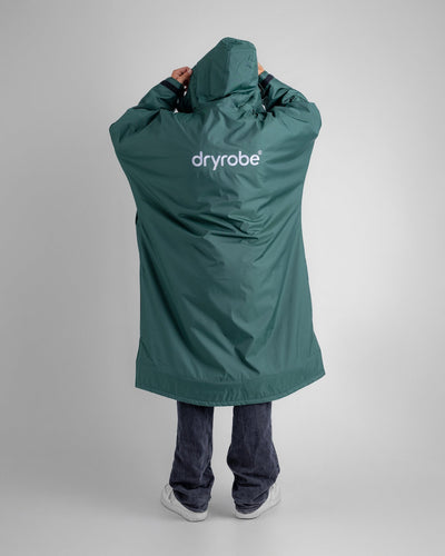 *MALE* in studio wearing AW25 Green Dryrobe® advance long sleeve 