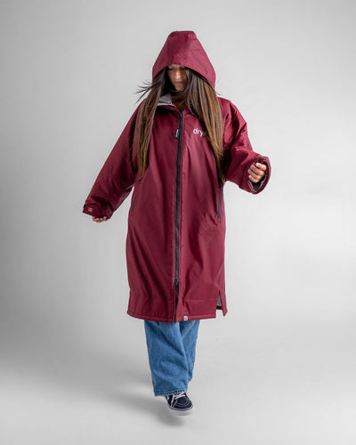 Female in studio wearing AW25 Burgundy Dryrobe® advance long sleeve 