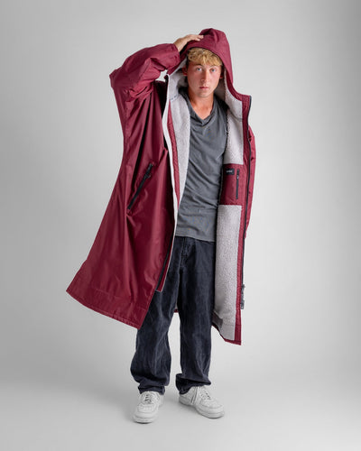 *MALE* in studio wearing AW25 Burgundy Dryrobe® advance long sleeve 