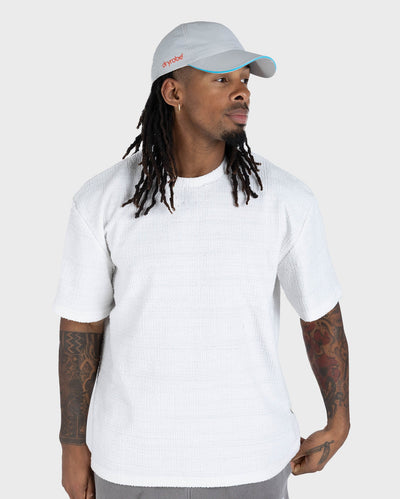 male in studio wearing grey Dryrobe® water resistant cap 