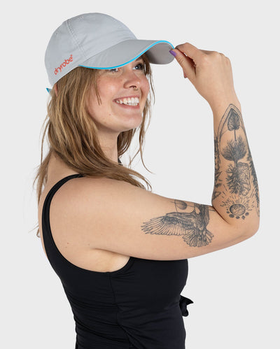 Woman in studio wearing grey Dryrobe® water resistant cap 