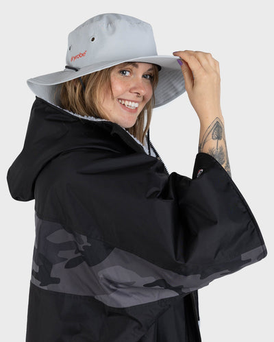 Female in studio wearing grey Dryrobe® water resistant wide brimmed hat 