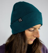 Studio shot of woman wearing deep sea blue Dryrobe® Beanie hat 