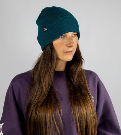 Studio shot of woman wearing deep sea blue Dryrobe® Beanie hat 
