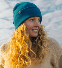 Lifestyle shot of woman wearing deep sea blue Dryrobe® Beanie hat 