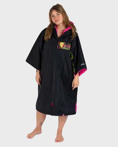 Adult female in studio wearing Dryrobe® Black pink camo remix