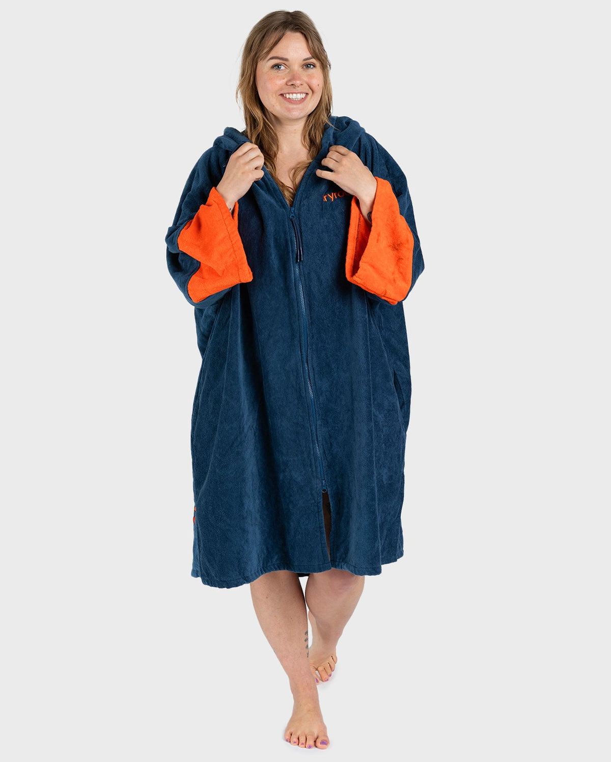 Female in studio wearing Dryrobe® Zip towel (blue orange)