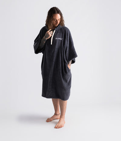 *MALE* Person wearing a dark grey hoodie with 'dryrobe' branding on a white background