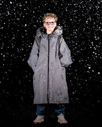 Boy stood in snow wearing dryrobe Advance Long Sleeve Changing Robe Alpine Range in Alpine Graphite 