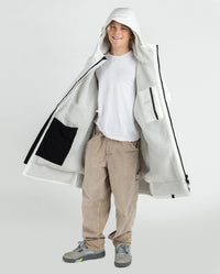 Boy wearing dryrobe Advance Long Sleeve Alpine Range changing robe in Alpine White showing the inner lining