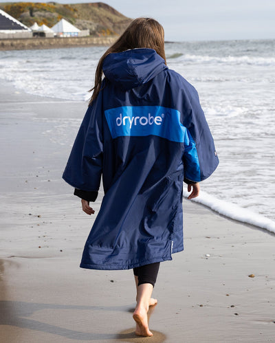 Kids navy cobalt Dryrobe® remix on beach
