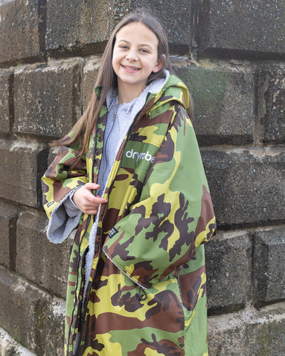 Kids camo grey Dryrobe® remix by beach wall 