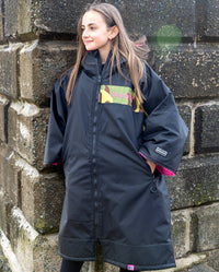 Kids black pink Dryrobe® remix by beach wall 
