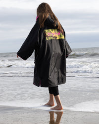 Kids black pink Dryrobe® remix on beach 
