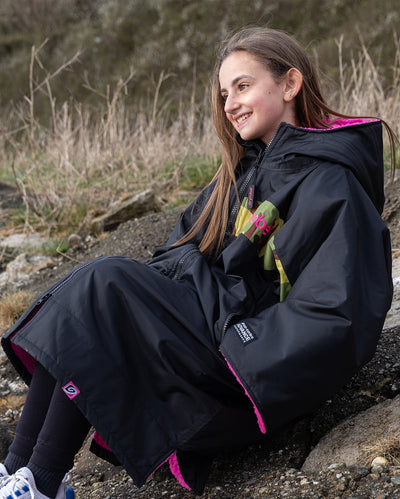 Kids black pink Dryrobe® remix on rocks 