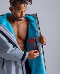 *MALE* in studio wearing 2025 LTD edition RNLI Dryrobe® showing inner zip 