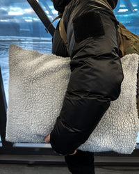 Male holding Dryrobe® black grey cushion cover
