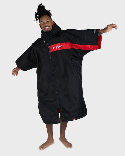 Adult male in studio wearing Dryrobe® Black red remix
