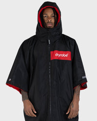 Adult male in studio wearing Dryrobe® Black red remix
