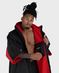 Adult male in studio wearing Dryrobe® Black red remix