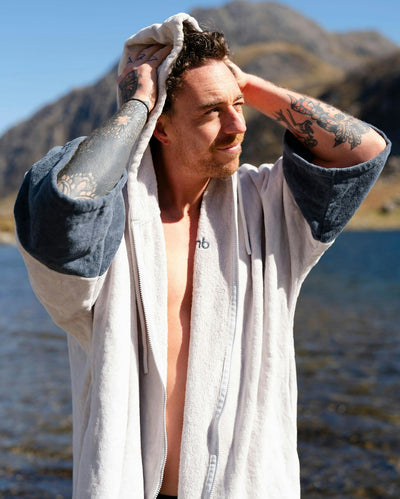 *MALE* by water wearing Dryrobe® Zip towel (nimbus cloud)
