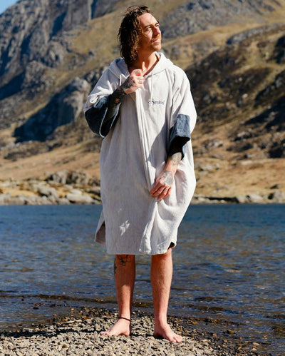 *MALE* by water wearing Dryrobe® Zip towel (nimbus cloud)