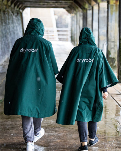*MALE* Two people walking in the rain in Dryrobe® ponchos