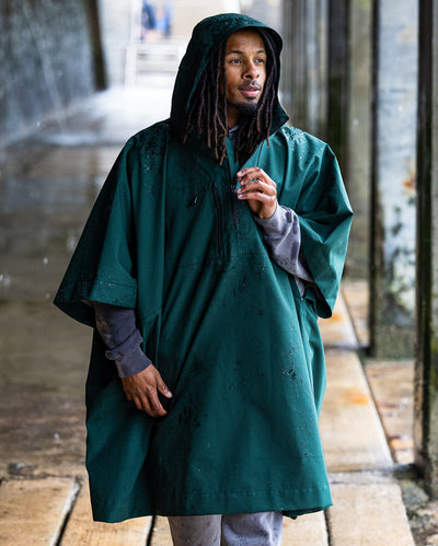 *MALE* Man stood in the rain wearing a Dryrobe® ponhco