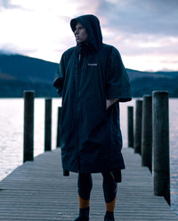 *MALE* stood on a pier, wearing dryrobe® Lite changing robe