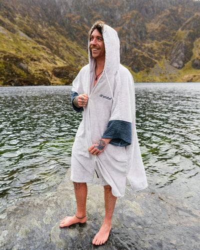 *MALE* by water wearing Dryrobe® Zip towel (nimbus cloud)