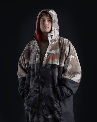 *MALE*Person wearing a camouflage jacket with a brand logo on a black background