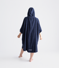 Person wearing a navy blue hooded towel robe on a white background