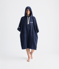 Person wearing a navy blue towel robe with a hood on a white background