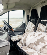 Car interior with Sand camouflage-patterned seat covers and cushion cover with Dryrobe® branding.