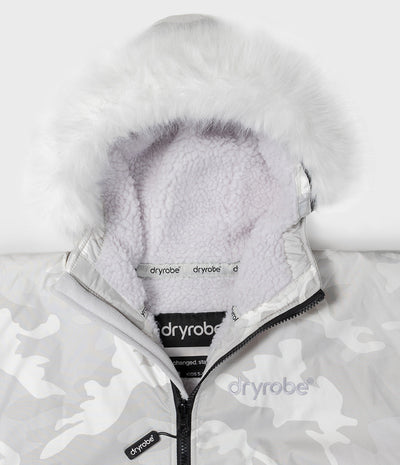 *MALE* Close-up of a Dryrobe hooded jacket with a white faux-fur trim around the hood and a light gray camouflage patterned shell. The interior fleece lining is pale lavender, and the Dryrobe brand name is visible on the inner neck label and zipper pull.