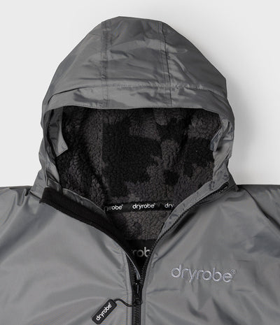 *MALE* Close-up of a gray Dryrobe hood and a black fleece-lined interior. The Dryrobe logo is visible on the chest and zipper pull.