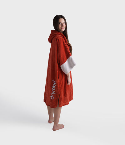 Person wearing a red dryrobe on a white background