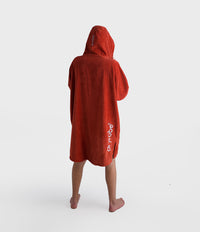 *MALE* Person wearing a red poncho with 'airbe' logo on a white background